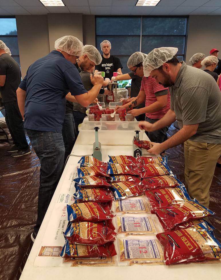 volunteers laying food donations on a table